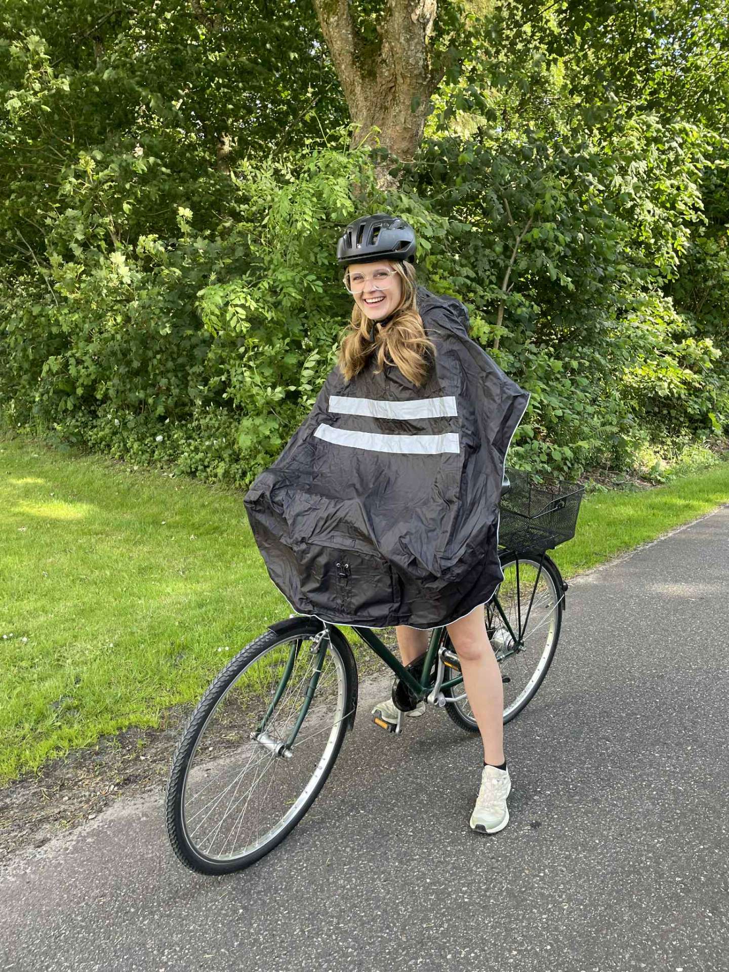 Cyklist tager NoRain poncho på over hovedet på cykelstien
